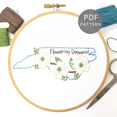 White flowering dogwood branch stitched inside the North Carolina outline.