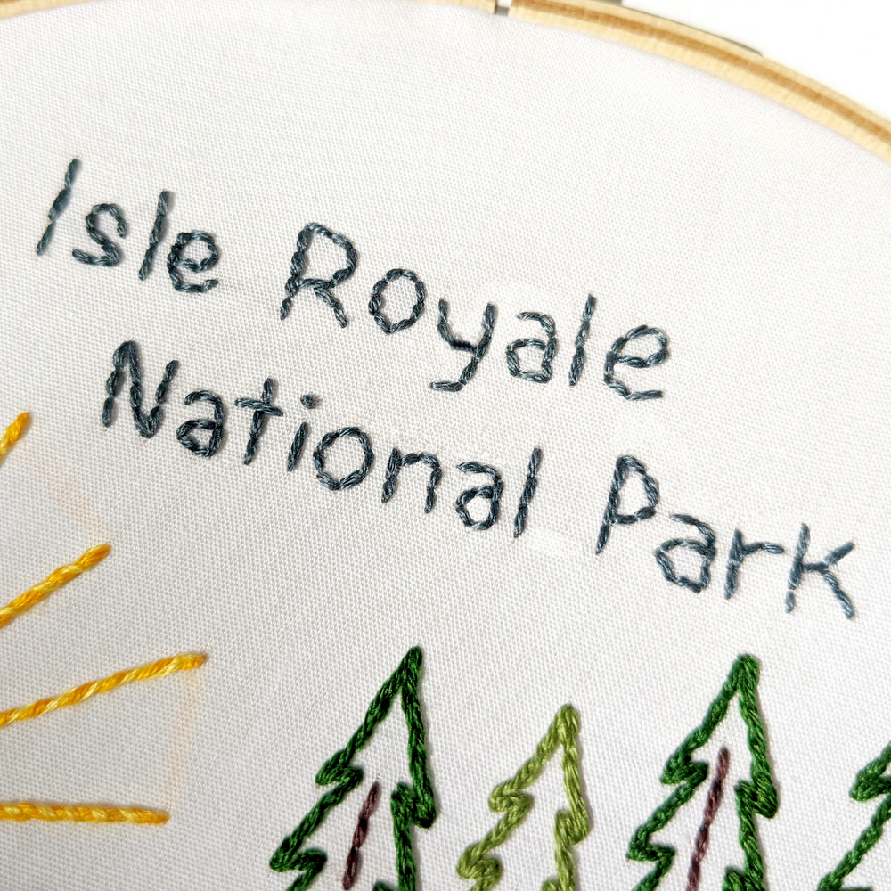 Hand stitched text in blue thread reads Isle Royale National Park