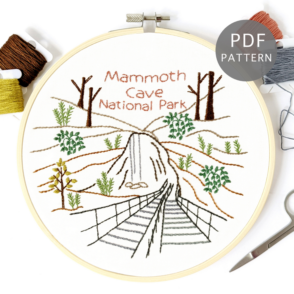 The entrance to Mammoth Cave National Park stitched on white fabric inside a 7-inch wooden hoop