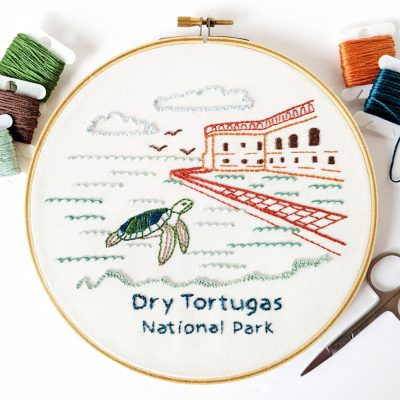 The Dry Tortugas National Park pattern stitched on white fabric inside a wooden hoop.