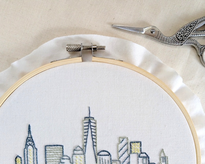 Trim the excess fabric around the edges roughly an inch larger than the hoop.